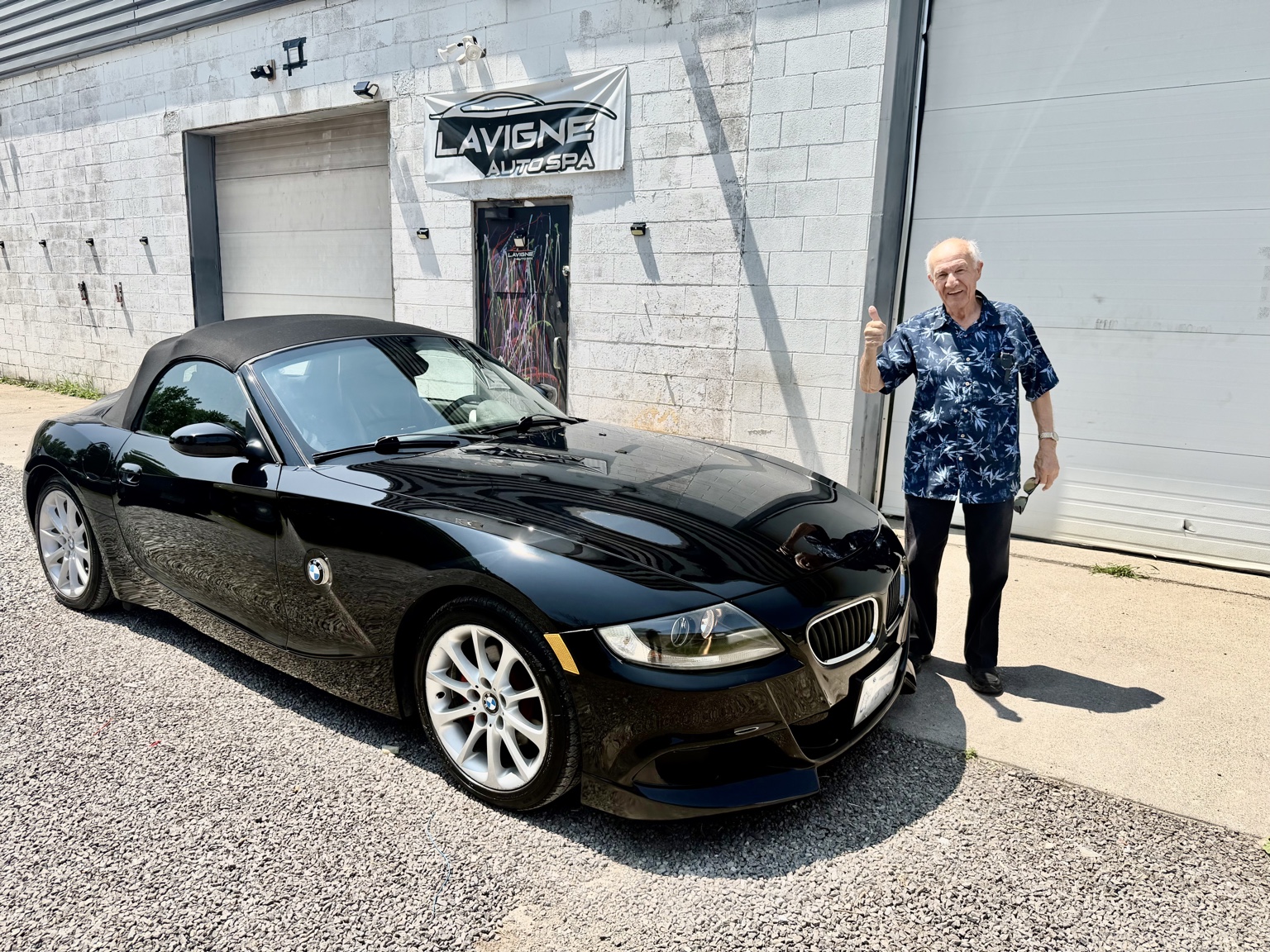 Happy customer with detailed BMW at Lavigne Autospa