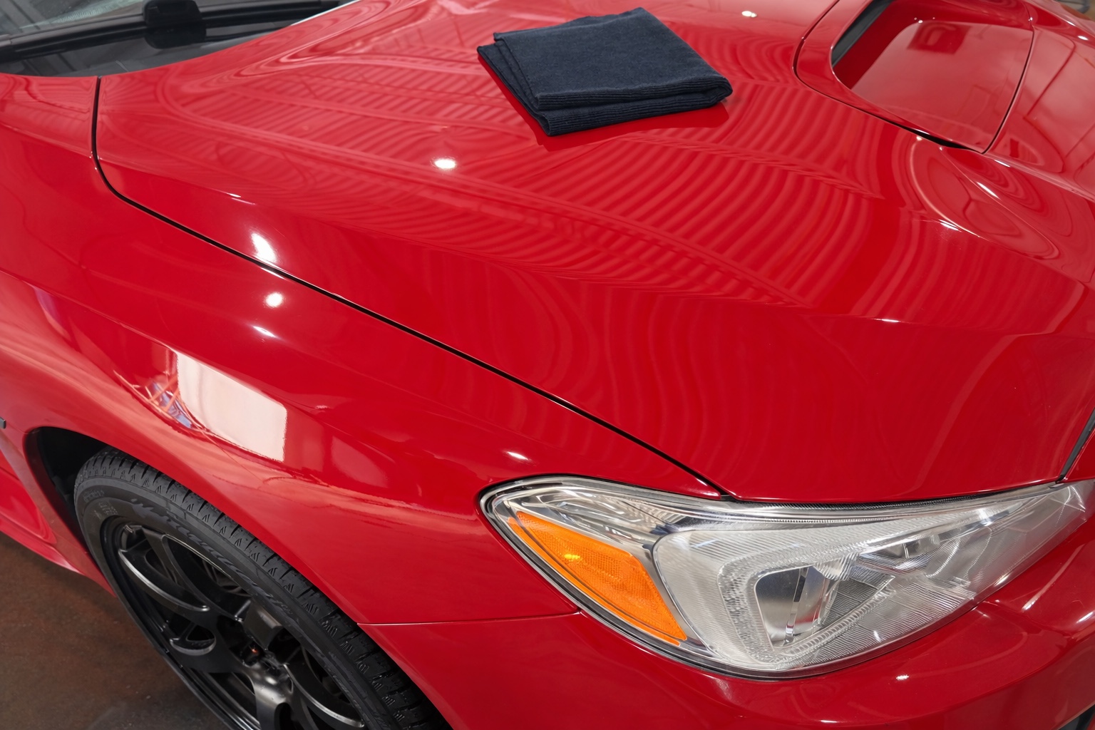 Red vehicle paint correction and polish result
